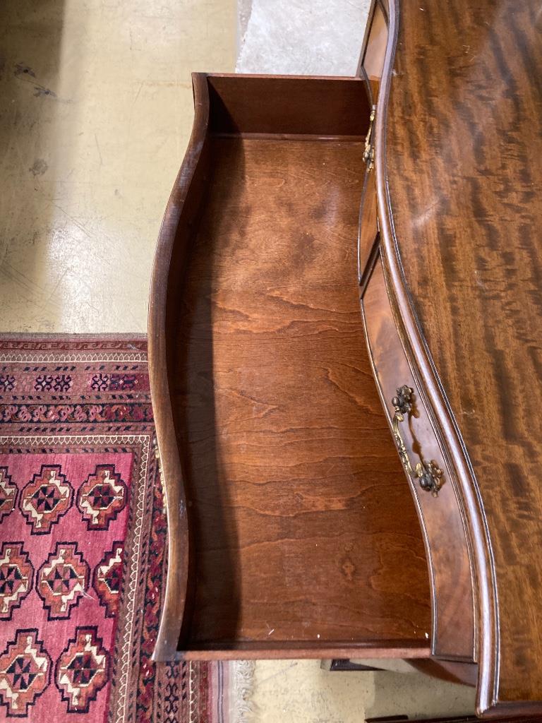 A George III style mahogany serpentine chest